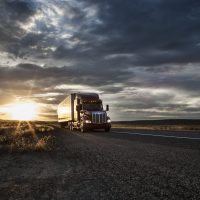 3/4 front view of a  commercial truck on the road at sunset  in eastern Washington, USA